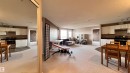 Spacious living area featuring light-colored carpeting, white kitchen cabinetry with dark countertops, and stainless steel appliances - 1318 330 Clareview Station Drive Nw, Edmonton, AB  - Indoor 
