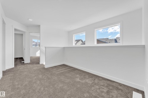 Bright, open space featuring plush grey carpeting and white walls - 57 710 Mattson Drive, Edmonton, AB - Indoor Photo Showing Other Room