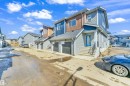 The property features a contemporary exterior with multi-toned siding, including blue and grey panels, and a wood-look accent on the upper level - 57 710 Mattson Drive, Edmonton, AB  - Outdoor 