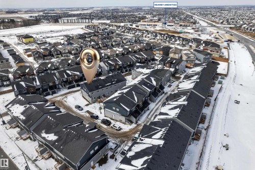 Aerial view of the property and surrounding neighborhood, featuring residential homes with dark roofs and light-colored siding - 57 710 Mattson Drive, Edmonton, AB -  With View