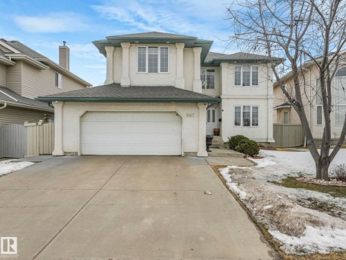The property features a stucco exterior, a two-car garage, and a concrete driveway - 1147 Lincoln Crescent, Edmonton, AB - Outdoor With Facade