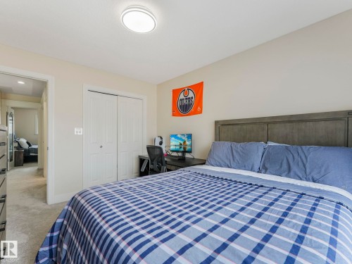 This room features light-colored walls and grey carpeted flooring - 1147 Lincoln Crescent, Edmonton, AB - Indoor Photo Showing Bedroom