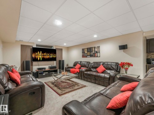 Spacious living area featuring light-colored walls, recessed lighting, and a textured drop ceiling - 1147 Lincoln Crescent, Edmonton, AB - Indoor