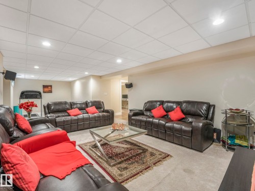 The living area features recessed lighting and a grid-paneled ceiling - 1147 Lincoln Crescent, Edmonton, AB - Indoor Photo Showing Other Room