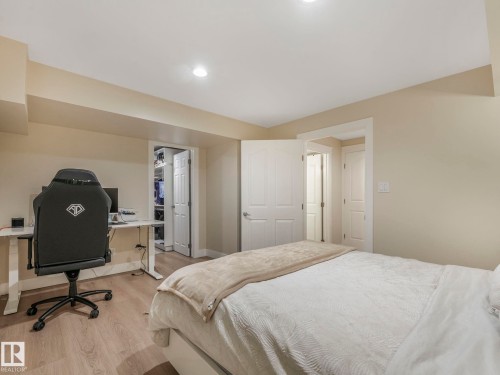 This room features light-colored walls, recessed lighting, and wood-style flooring - 1147 Lincoln Crescent, Edmonton, AB - Indoor Photo Showing Bedroom