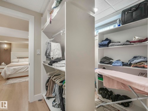 Walk-in closet featuring extensive built-in shelving and hanging space - 1147 Lincoln Crescent, Edmonton, AB - Indoor With Storage