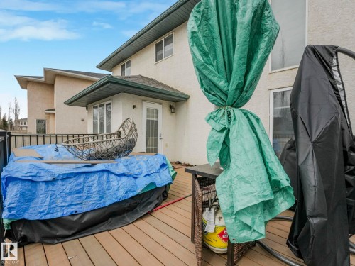 The property features an exterior deck with wood flooring and a black railing - 1147 Lincoln Crescent, Edmonton, AB - Outdoor With Exterior