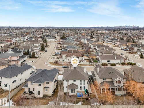 The property features a two-story design with a light-colored exterior and a dark roof, situated within a developed residential area - 1147 Lincoln Crescent, Edmonton, AB - Outdoor With View