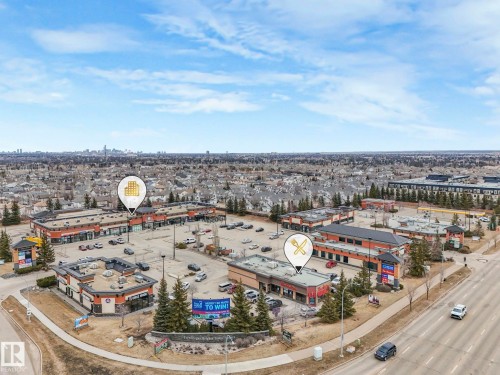 Aerial view of the neighborhood featuring commercial buildings, parking areas, and a visible road - 1147 Lincoln Crescent, Edmonton, AB - Outdoor With View