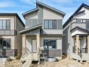 The property features a modern exterior with varied siding, a striking roofline, and a prominent front entrance with columns - 275 Munn Way, Leduc, AB  - Outdoor 