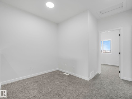 This room features light grey carpet, white walls, and a recessed ceiling light - 275 Munn Way, Leduc, AB - Indoor Photo Showing Other Room