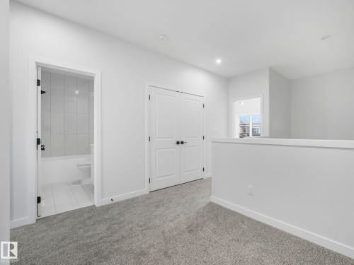Interior room with light gray carpet, white walls, recessed lighting, and a white interior door - 275 Munn Way, Leduc, AB - Indoor Photo Showing Other Room