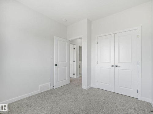 This room features light grey carpeting, white walls, and white trim - 275 Munn Way, Leduc, AB - Indoor Photo Showing Other Room