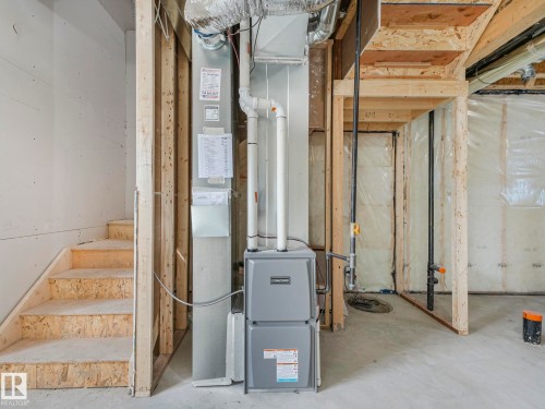 The property includes a utility area with a furnace unit and exposed ductwork - 275 Munn Way, Leduc, AB - Indoor Photo Showing Basement
