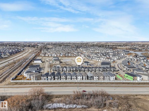Aerial view of the property and its surrounding area, featuring a developed neighborhood with residential structures and established infrastructure including roadways - 275 Munn Way, Leduc, AB - Outdoor With View
