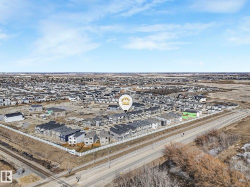 Aerial view showcasing the community with numerous residential properties under a clear sky - 275 Munn Way, Leduc, AB - Outdoor With View