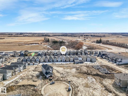 Aerial view of the property with a visible road network and surrounding open fields - 275 Munn Way, Leduc, AB - Outdoor With View