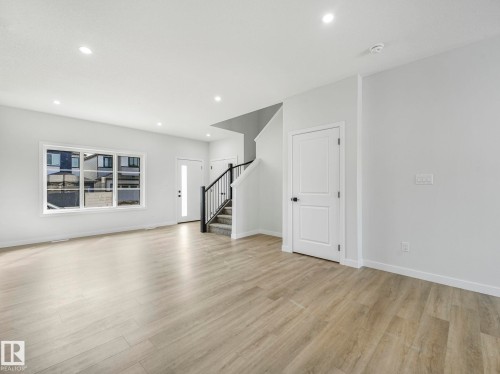 Living space featuring light-toned flooring, white walls, and recessed lighting - 275 Munn Way, Leduc, AB - Indoor Photo Showing Living Room