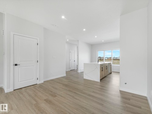Open concept living area with light-colored flooring, white walls, and recessed lighting - 275 Munn Way, Leduc, AB - Indoor Photo Showing Other Room