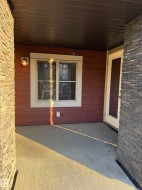 The property features a concrete patio area with stone veneer accent walls - 