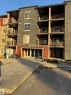 The property features a multi-story building with balconies, a stone-accented facade, and large windows - 104 3207 James Mowatt Trail, Edmonton, AB  - Outdoor With Facade 