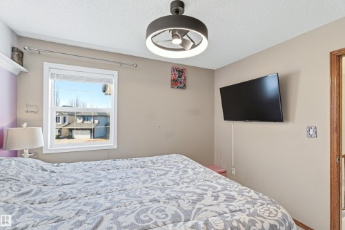 This room features a window providing natural light, a ceiling-mounted light fixture, and neutral-toned walls - 442 Hunters Green, Edmonton, AB - Indoor Photo Showing Bedroom