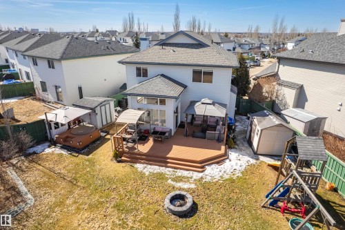 The property features a spacious backyard with a large wooden deck, complete with outdoor seating and a gazebo - 442 Hunters Green, Edmonton, AB - Outdoor With Deck Patio Veranda With Exterior