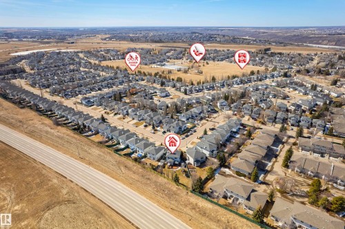 Aerial view of a residential neighbourhood with a paved road and open fields - 442 Hunters Green, Edmonton, AB - Outdoor With View