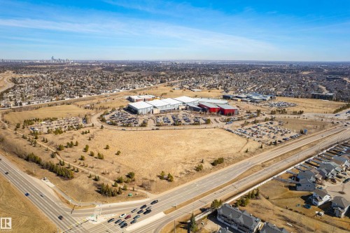Aerial view showcasing the surrounding neighborhood, roads, and distant cityscape - 442 Hunters Green, Edmonton, AB - Outdoor With View