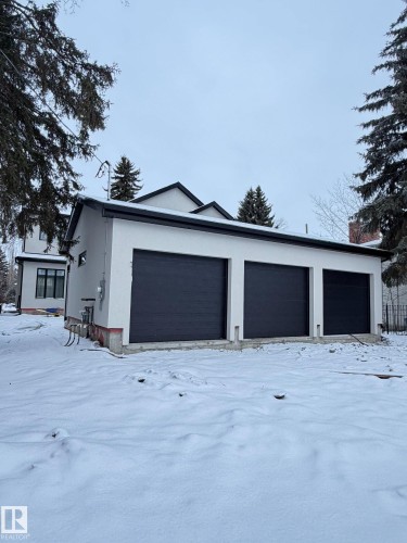 Detached three-car garage with black doors and a white exterior - 10223 130 Street, Edmonton, AB - Outdoor