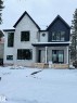 The property features a stone and stucco exterior with dark-framed windows and a covered front entrance - 10223 130 Street, Edmonton, AB  - Outdoor 