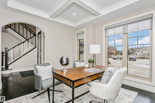 Office space featuring large windows, dark hardwood flooring, and a coffered ceiling - 3435 Keswick Boulevard, Edmonton, AB 