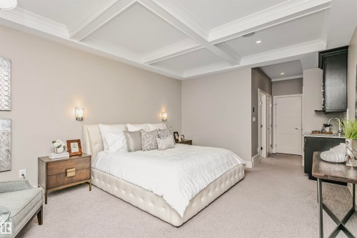 This spacious room features a coffered ceiling and light-colored carpeting - 3435 Keswick Boulevard, Edmonton, AB 