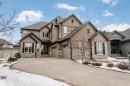 The property features an attractive exterior with a blend of stucco and stone finishes - 3435 Keswick Boulevard, Edmonton, AB 