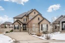 The property showcases a multi-level design with a stucco and stone exterior facade - 3435 Keswick Boulevard, Edmonton, AB 