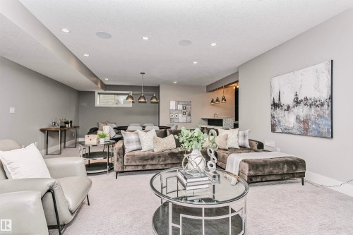 Spacious living area featuring recessed lighting, light-colored carpeting, and a visible wet bar area - 3435 Keswick Boulevard, Edmonton, AB 