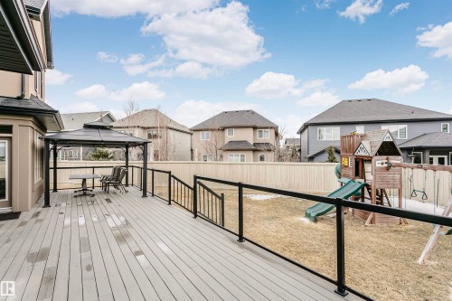 Spacious outdoor deck with a gazebo, glass railing, and a fenced yard - 3435 Keswick Boulevard, Edmonton, AB 