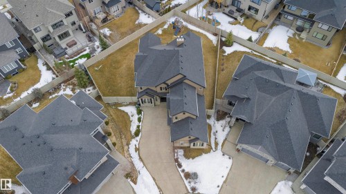 This property features a multi-level design, a dark gray shingle roof, and a paved driveway - 3435 Keswick Boulevard, Edmonton, AB 