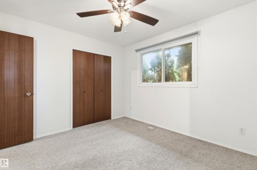 This room features light-colored carpeting, white walls, and a window providing natural light - 1707 65 Street, Edmonton, AB - Indoor Photo Showing Other Room