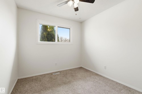 Bright room featuring neutral-toned walls, a window providing natural light, and a ceiling fan - 1707 65 Street, Edmonton, AB - Indoor Photo Showing Other Room