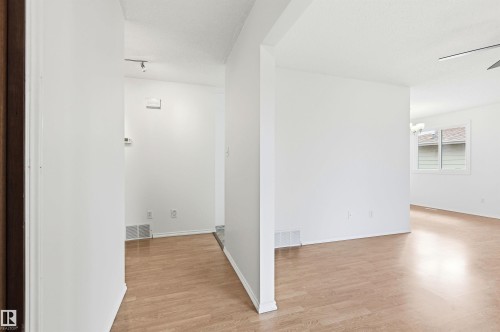 The property features light-toned flooring, white walls, and a window providing natural light - 1707 65 Street, Edmonton, AB - Indoor Photo Showing Other Room