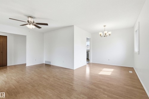The property features light wood flooring, white walls, and a window providing natural light - 1707 65 Street, Edmonton, AB - Indoor Photo Showing Other Room