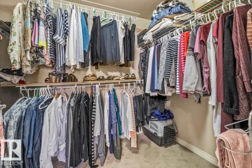 The property features a walk-in closet with carpet flooring - 332 612 111 Street, Edmonton, AB - Indoor With Storage