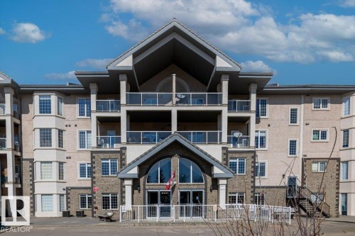 The property features a multi-story facade with balconies, a pitched roofline, and varied exterior finishes including stucco and brick accents - 332 612 111 Street, Edmonton, AB - Outdoor With Facade