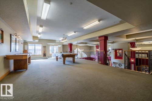 Expansive recreation area featuring carpeted flooring, large windows, and overhead lighting - 332 612 111 Street, Edmonton, AB - Indoor Photo Showing Other Room