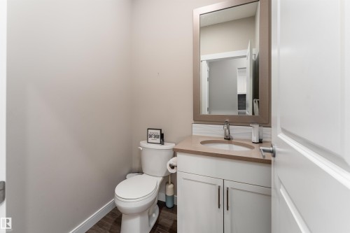 Bathroom featuring a vanity with a light-colored countertop, a framed mirror, and a toilet - 6193 Carr Road, Edmonton, AB - Indoor Photo Showing Bathroom