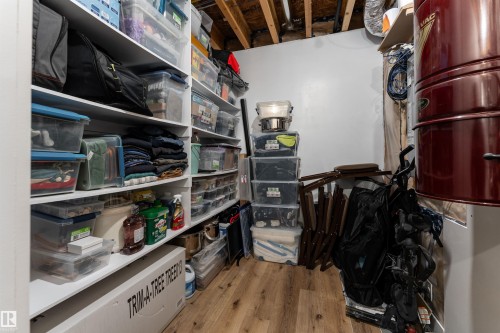 The property features dedicated storage space with extensive shelving and durable flooring - 6193 Carr Road, Edmonton, AB - Indoor
