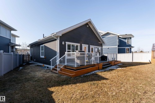 The property features a private backyard with a deck and a wooden staircase - 6193 Carr Road, Edmonton, AB - Outdoor With Exterior