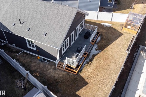 The property features a dark gray exterior with white trim, a multi-level deck with white railings, and a greenhouse - 6193 Carr Road, Edmonton, AB - Outdoor