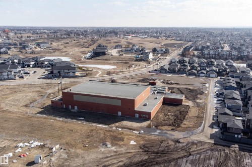 Aerial view showcasing the property's location within a developed neighborhood, featuring residential homes and open spaces - 6193 Carr Road, Edmonton, AB - Outdoor With View